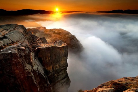 Magical sunrise over misty rocks near Prekestolen