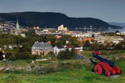 View from Kristianstenfestning over Trondheim with red cannon in the foreground, Trondheim, Norway