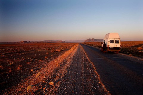 Transporter on lonely road in breathtaking evening scenery, Gourrama, Morocco