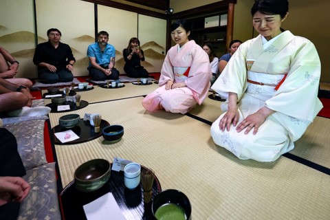 Two tea masters and participants at tea ceremony, traditional ambiance, Kyoto, Higashiyama, Japan