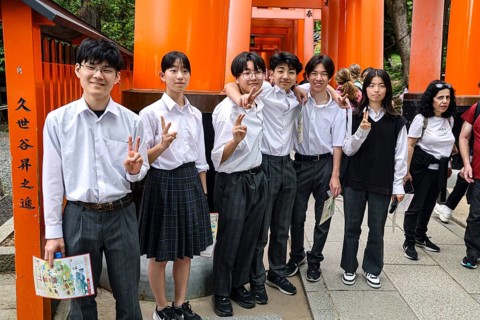 Students pose in front of torii at Fushimi Inari Shrine in Kyoto, Fushimi, Kyoto, Japan