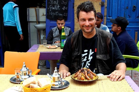 Man enjoying couscous in an atmospheric restaurant in the old town, Essaouira, Morocco