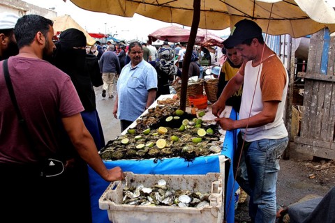 A man sells seafood at a market stall in Essaouira, Essaouira, Morocco