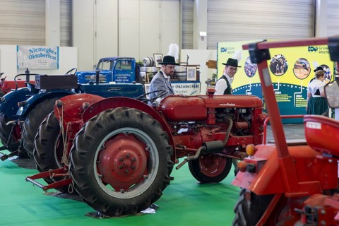 Visitors look at old agricultural machinery as part of the special exhibition on 100 years of Green