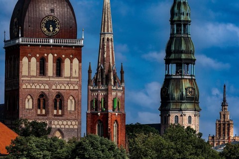 Cathedral towers, Anglican Church and St. Peter's Church in Riga against a blue sky, Riga, Vidzeme,