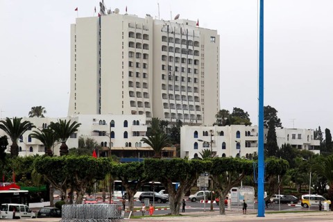 Large modern hotel building surrounded by palm trees and traffic in a city view, Agadir, zero,