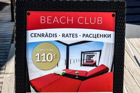 Beach club price table with information in several languages, Majori, Jurmala, Latvia