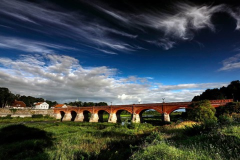Impressive brick bridge in the Windau valley under a cloudy sky, Kuldiga, Windau, Latvia