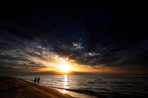 Sunset on Kolka beach with walkers on the shore, Kolka, Latvia