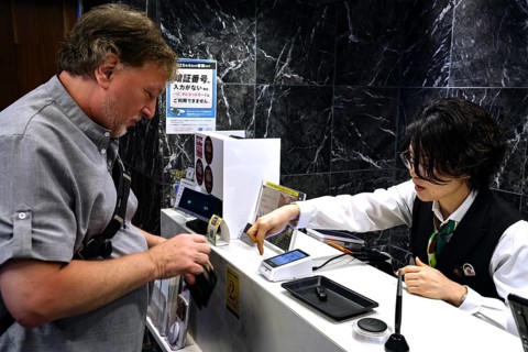 Man pays at the cash register in a restaurant, Kobe, Japan