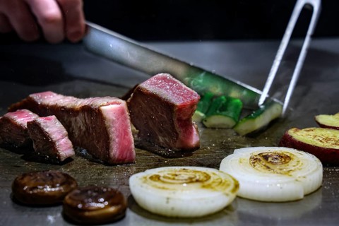 Kobe beef is cut teppanyaki style in restaurant, Kobe, Japan