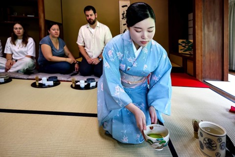 Tea master during a tea ceremony with guests, serving traditional green tea, Kyoto, Higashiyama,
