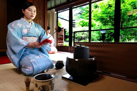 Tea master in a kimono during a contemplative tea ceremony, Kyoto, Higashiyama, Japan