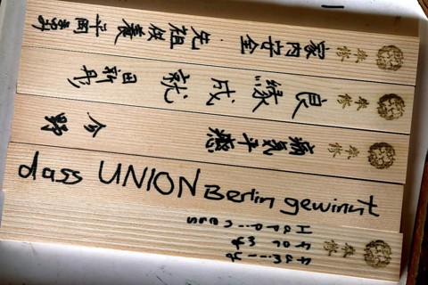 Ema wooden plates with Japanese characters and small symbols, traditionally used in temples, Kyoto,