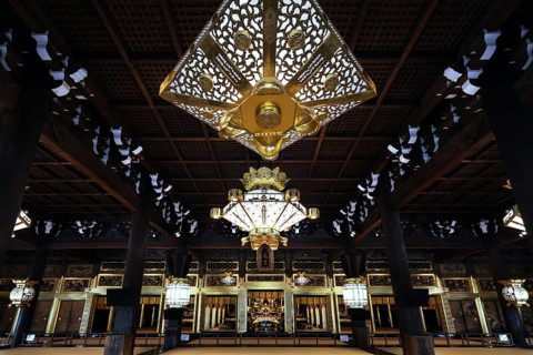 Interior view of Nishi Hongan-ji Temple with impressive chandelier and ornate woodwork, Kyoto,