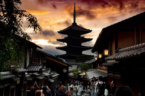 Yasaka Pagoda at sunset, framed by traditional architecture and a dramatic sky, Kyoto, Higashiyama,