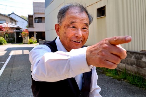 Friendly host points smiling in one direction in Kanazawa, Kanazawa, Japan