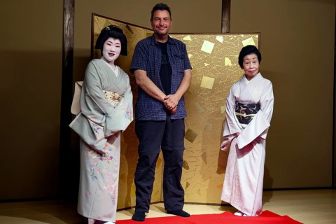 Two geishas and a man pose in the Nishi Chaya tea house district in Kanazawa, Kanazawa, Ishikawa,