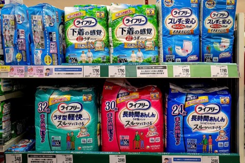 Shelf in Matsumoto supermarket with various diaper brands, Matsumoto, Nagano, Japan