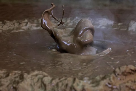 A bubbling mud well in the solfatar field of Kamado Jigoku, Beppu, Kyushu, Japan