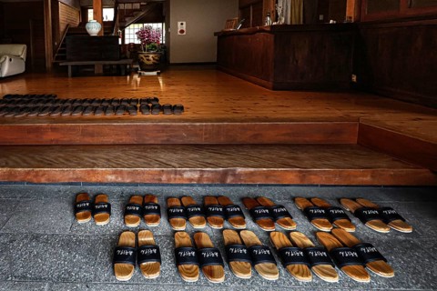 Entrance to Ryokan Minshuku Asogen with carefully arranged shoes