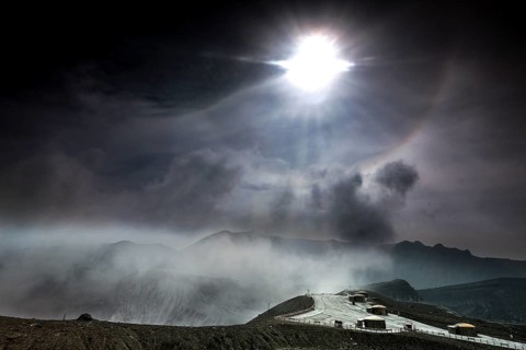 Intense sunlight and fog over the crater and bunker at Nakadake, Aso, Aso, Kyushu, Japan
