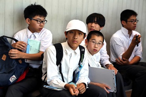 Students relax at Hiroshima Peace Museum after visiting, Hiroshima, Japan