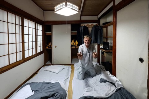 Japanese room with tatami flooring and futons. Guest preparing for overnight stay, Beppu, Oita,