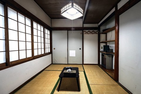 Minimalist Japanese room with tatami floor and sliding walls, Beppu, Oita, Japan