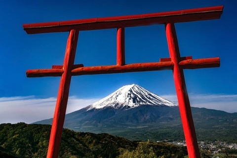 Red torii with a view of snow-capped Mount Fuji in Kawaguchi-ko, Kawaguchi-ko, Yamanashi, Japan