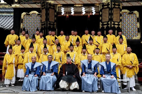Ceremonial group photo of Shinto priests wearing traditional dress in front of Toshogu Shrine,