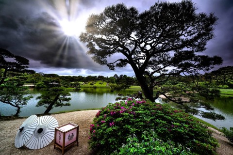 Painting view of Korakuen of Okayama Castle with bright sun and Japanese umbrellas, Okayama,