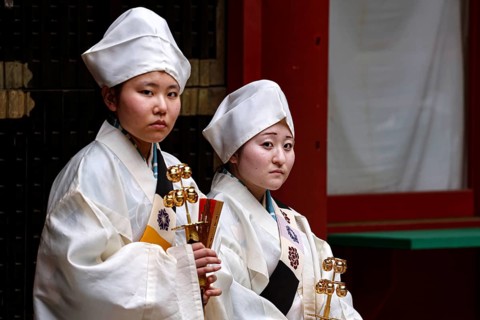 Two female carpenters in traditional dress in the courtyard of Toshogu Shrine, Nikko, Tochigi,