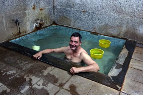 Man relaxing in a traditional public bath in Yamanouchi