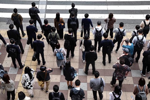 People gather at a busy pedestrian crossing, Osaka, Umeda, Japan
