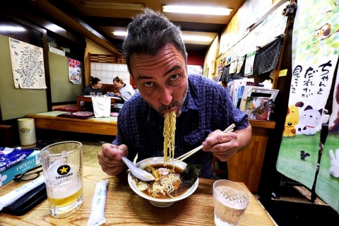 Man enjoying ramen in a cozy Japanese restaurant, Yamanouchi, Japan