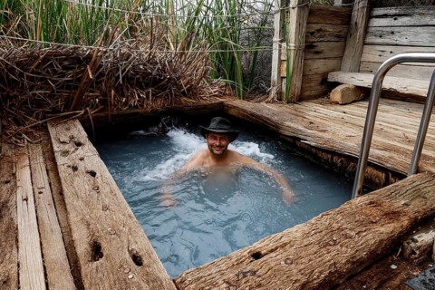 Person in a natural spring surrounded by wood in the outback, Oodnadatta Track, null, Australia