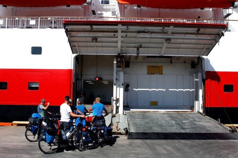 Cyclists prepare at the loading dock of a ship, Kirkenes, Finnmark, Norway
