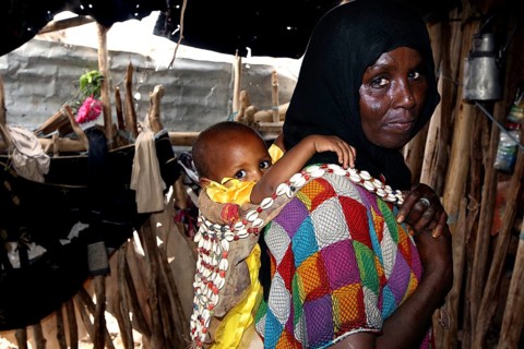Muhammad's mother and Fatimeh in traditional clothes, the child on the back, Ahmedela, Tigray,