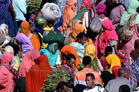 Crowds of people wearing colorful robes at a market, Awaday, Ethiopia