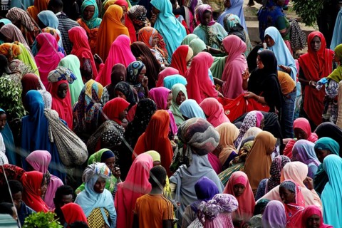 Large crowd in colorful clothes at a market in Awaday, Awaday, Ethiopia