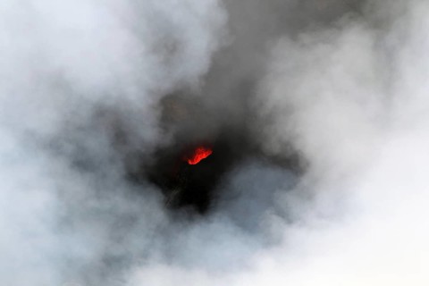 Smouldering volcano with a crater partly covered by haze, Erta Ale, Ethiopia