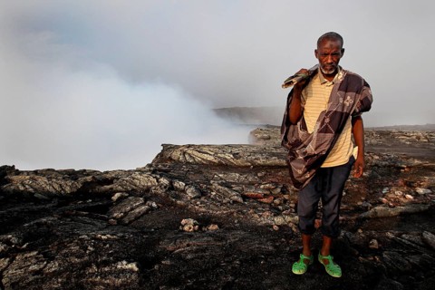 Police officer Muhammed at the edge of the smoking crater of Erta Ale, Erta Ale, Afar, Ethiopia