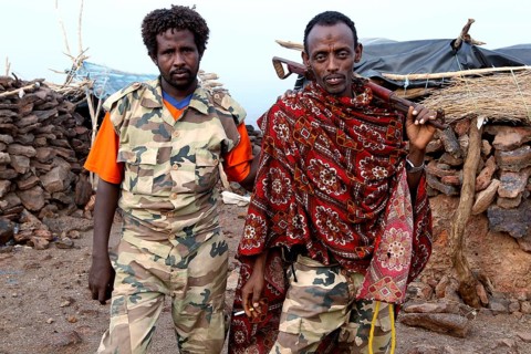 Two soldiers in traditional and military clothing at Erta Ale Camp, Erta Ale, Ethiopia