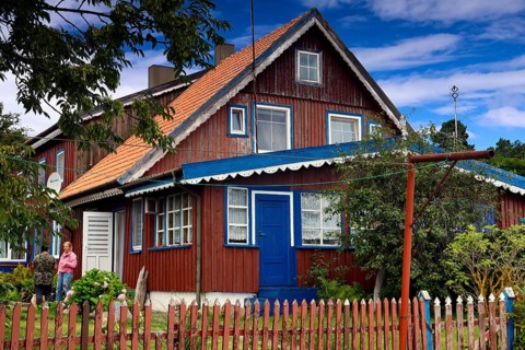 Traditional Lithuanian wooden house with colorful exterior and garden, Nida, Curonian Spit,