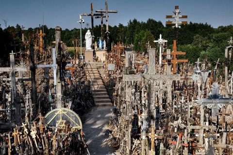 Overview of countless crosses on a hill with trees in the background, Siauliai, Lithuania