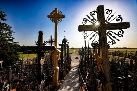 Path through the crosses in evening light on the Hill of Crosses in Siauliai, Siauliai, Lithuania