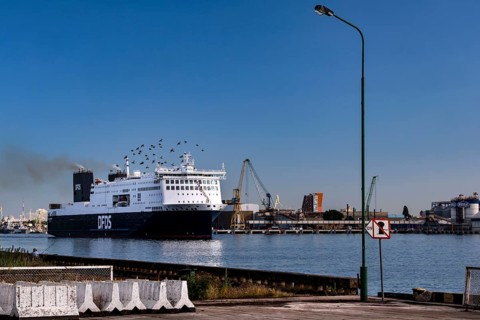 Ferry in the port of Sandkrug in the Curonian Lagoon surrounded by industrial structures, Sandkrug,