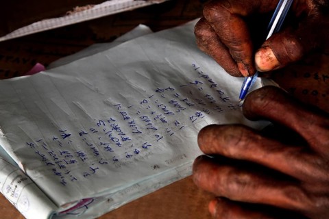 A person writes with a pen on paper in close-up, Mekele, Ethiopia