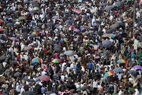 Dense crowd with colorful umbrellas at a busy market, Lalibela, Ethiopia